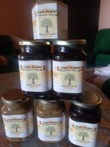 Produits en pots étiquetés sur table — Coopérative Aimran, région de Guercif